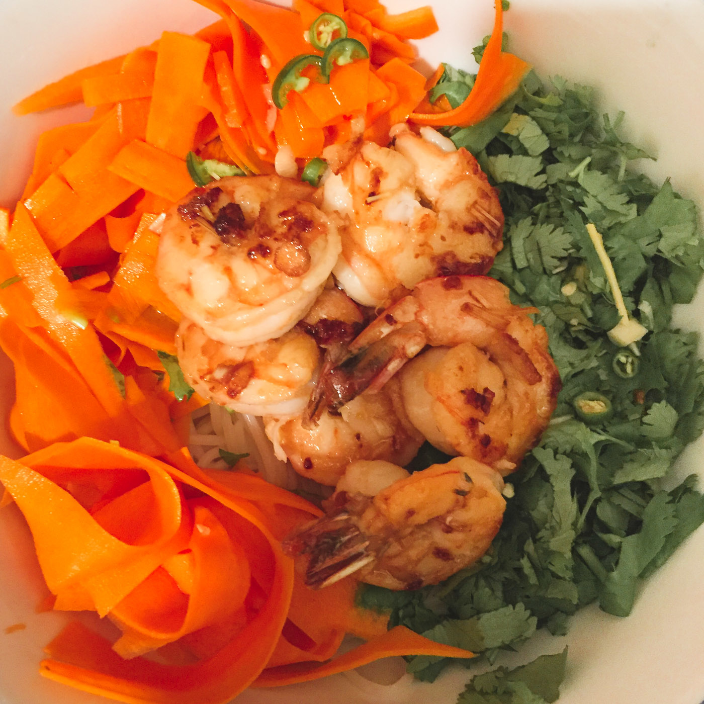 Fresh summer noodle salad with juicy shrimps, pickled carrots, lots of cilantro and jalapeño.