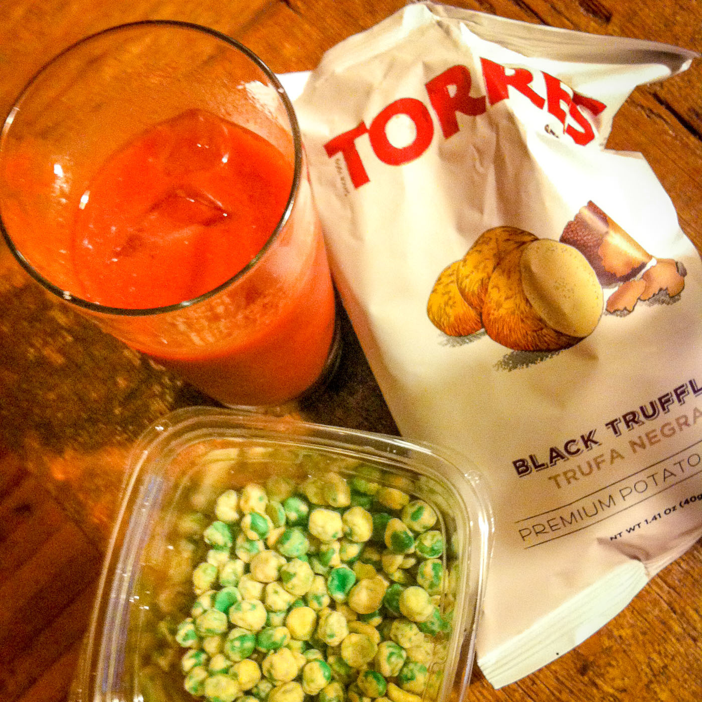 A Bloody Mary with wasabi peas for that perfect after work lift. For the truffle fans, try these insane black truffle potato chips too with a glass of wine.
