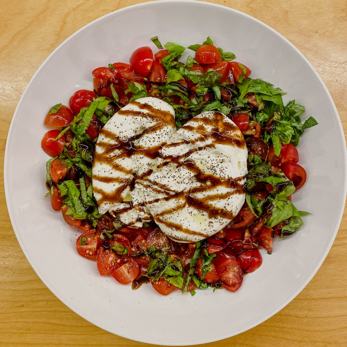 Quick and easy. Tomatoes, loads of basil, a nice burrata, drizzle with olive oil and balsamic glaze. 